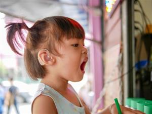 Young child wearing hearing aid. 